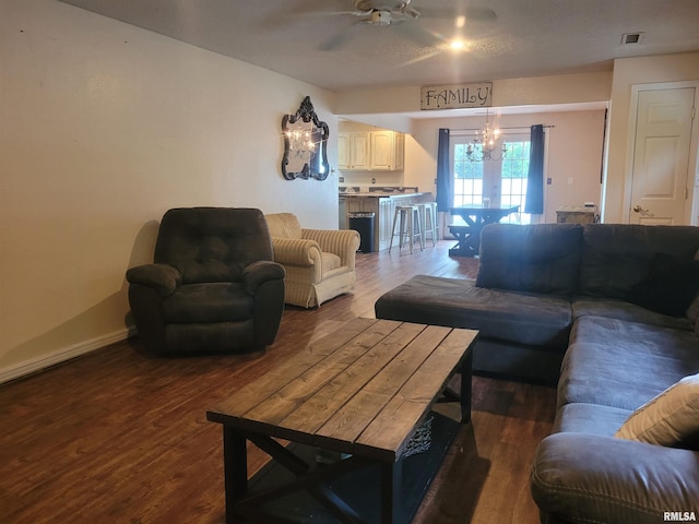 living room featuring ceiling fan, dark wood-style floors, and visible vents