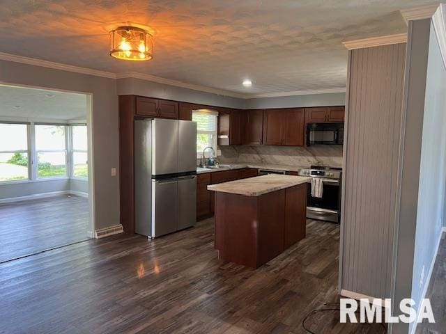 kitchen featuring freestanding refrigerator, black microwave, light countertops, dark wood-style floors, and range