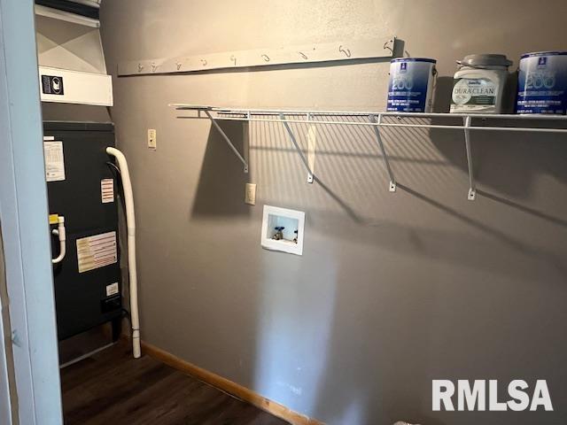 laundry area with baseboards, laundry area, washer hookup, and dark wood-type flooring