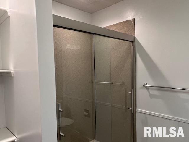 bathroom with a shower with shower door