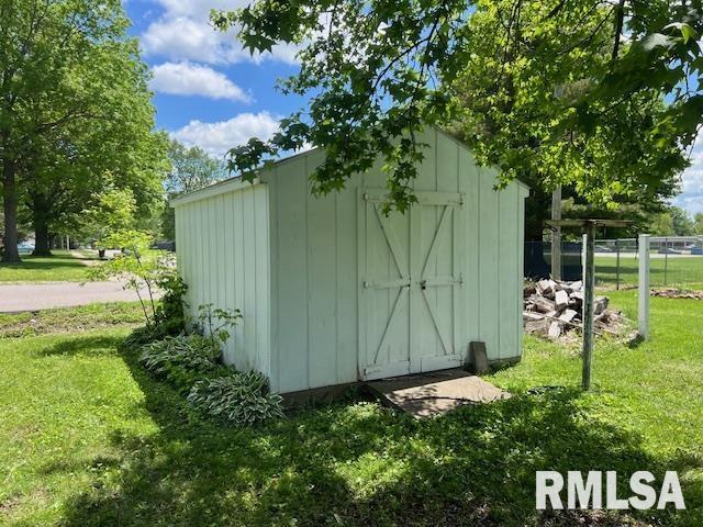 view of shed featuring fence