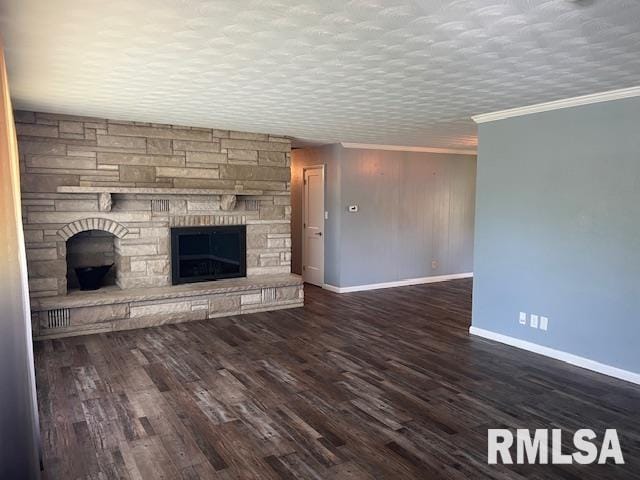 unfurnished living room featuring baseboards, a stone fireplace, ornamental molding, and wood finished floors