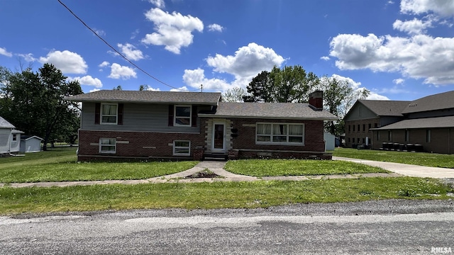 1908 E Oak St, West Frankfort, IL 62896 - split level home featuring entry steps, a chimney, brick siding, and a front yard