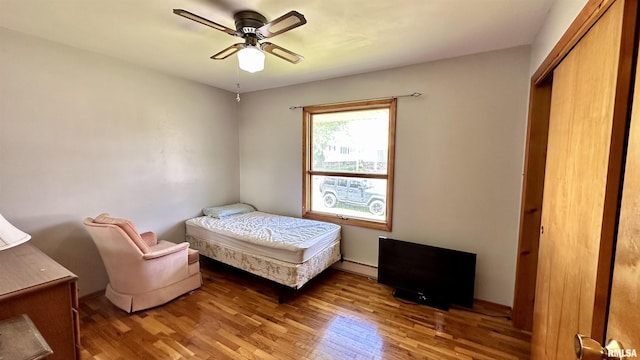 1908 E Oak St, West Frankfort, IL 62896 - bedroom featuring baseboard heating, light wood finished floors, and ceiling fan