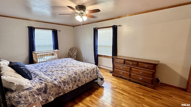 1908 E Oak St, West Frankfort, IL 62896 - bedroom featuring light wood-style floors, a baseboard radiator, a ceiling fan, and ornamental molding
