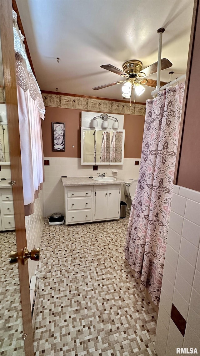1908 E Oak St, West Frankfort, IL 62896 - full bathroom featuring a wainscoted wall, vanity, tile walls, and a ceiling fan