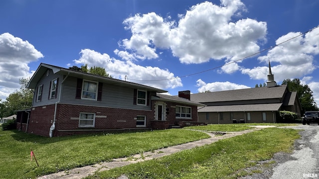 1908 E Oak St, West Frankfort, IL 62896 - split level home with a front lawn, a chimney, and brick siding