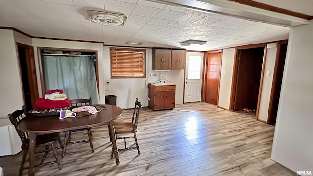 1908 E Oak St, West Frankfort, IL 62896 - dining area with crown molding and light wood-style floors