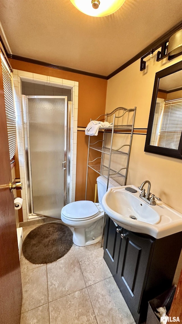 1908 E Oak St, West Frankfort, IL 62896 - bathroom with toilet, vanity, ornamental molding, tile patterned floors, and a shower stall