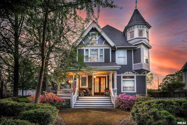 301 W High St, Anna, IL 62906 - victorian home featuring a porch, a shingled roof, and fence
