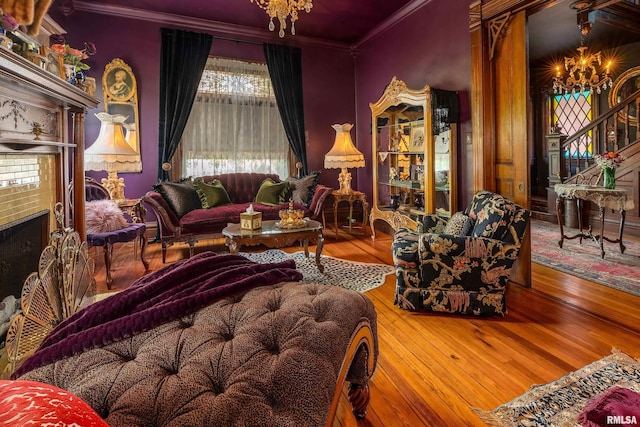301 W High St, Anna, IL 62906 - living area with a chandelier, ornamental molding, wood-type flooring, stairway, and a brick fireplace