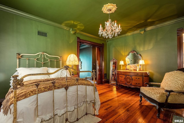 301 W High St, Anna, IL 62906 - bedroom with a chandelier, crown molding, and hardwood / wood-style flooring