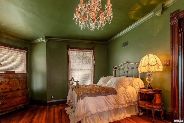 301 W High St, Anna, IL 62906 - bedroom featuring hardwood / wood-style flooring, ornamental molding, a chandelier, and baseboards
