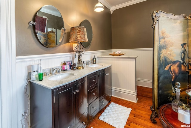 301 W High St, Anna, IL 62906 - full bathroom with wainscoting, crown molding, wood finished floors, and double vanity