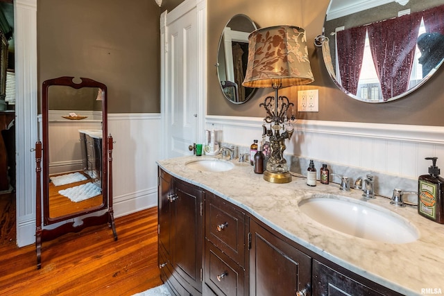 301 W High St, Anna, IL 62906 - bathroom with a wainscoted wall, wood finished floors, and double vanity