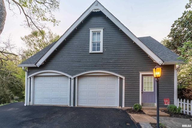 301 W High St, Anna, IL 62906 - garage featuring asphalt driveway and fence