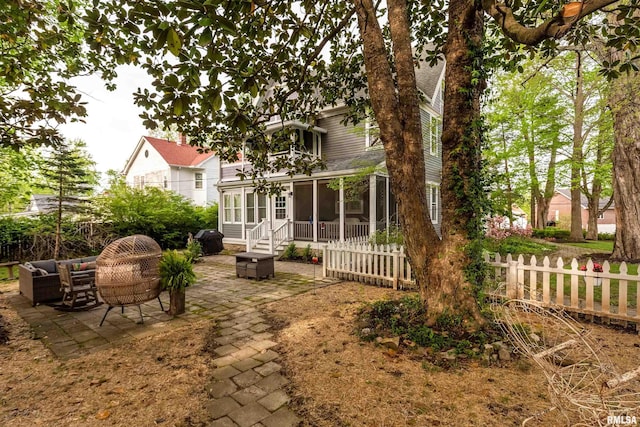 301 W High St, Anna, IL 62906 - rear view of house with a sunroom, a patio area, and an outdoor hangout area