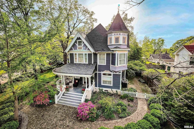 301 W High St, Anna, IL 62906 - victorian house with covered porch, fence, stairway, and a shingled roof