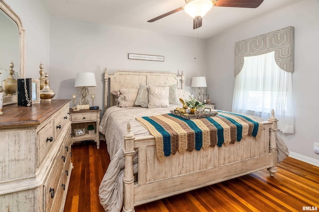 bedroom with dark wood-style floors, baseboards, and a ceiling fan