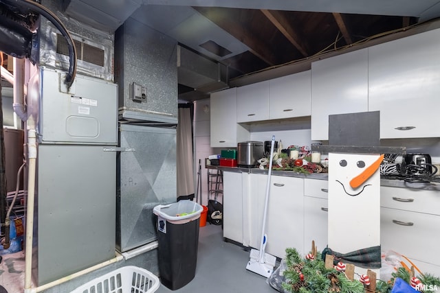 kitchen featuring white cabinets and concrete floors