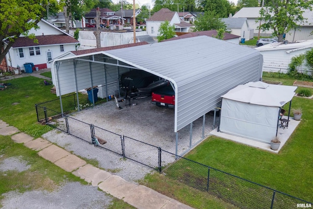 view of parking with a gate, a residential view, and a detached carport