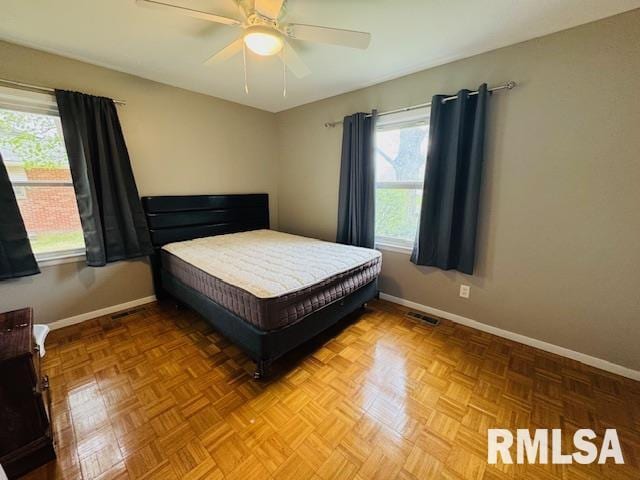 bedroom featuring baseboards and ceiling fan