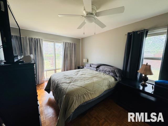 bedroom featuring multiple windows and a ceiling fan