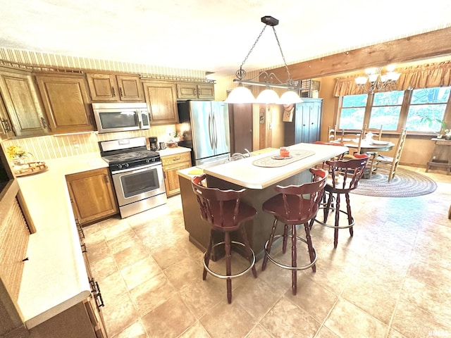 7 Lakewood Dr, Centralia, IL 62801 - kitchen featuring stainless steel appliances, light countertops, and brown cabinetry