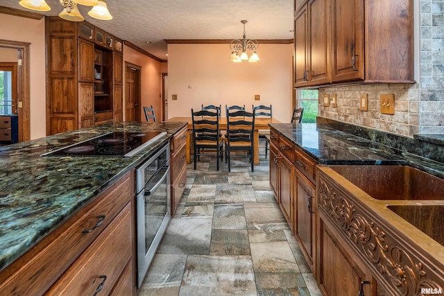 500 Swink Ln, Jonesboro, IL 62952 - kitchen featuring stainless steel oven, black electric stovetop, a chandelier, stone tile flooring, and healthy amount of natural light