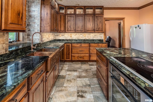 500 Swink Ln, Jonesboro, IL 62952 - kitchen featuring appliances with stainless steel finishes, a sink, decorative backsplash, stone tile flooring, and brown cabinetry