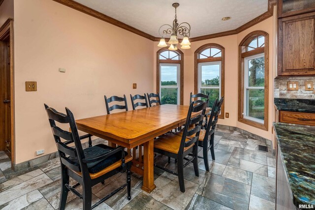 500 Swink Ln, Jonesboro, IL 62952 - dining area with crown molding, stone tile floors, baseboards, and a chandelier