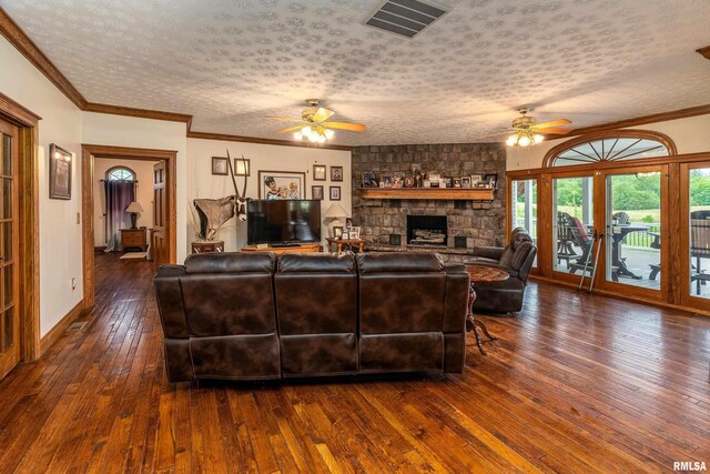 500 Swink Ln, Jonesboro, IL 62952 - living area featuring ceiling fan, a textured ceiling, dark wood finished floors, a fireplace, and ornamental molding