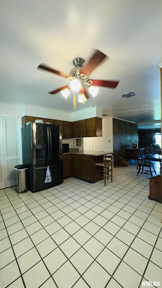 15048 State Highway 14, Benton, IL 62812 - kitchen with black refrigerator with ice dispenser, dark brown cabinets, a ceiling fan, and light tile patterned floors