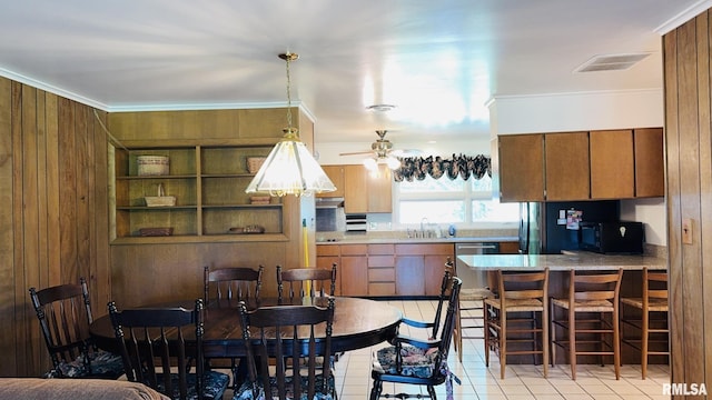 15048 State Highway 14, Benton, IL 62812 - dining area with wooden walls, light tile patterned flooring, crown molding, and a ceiling fan