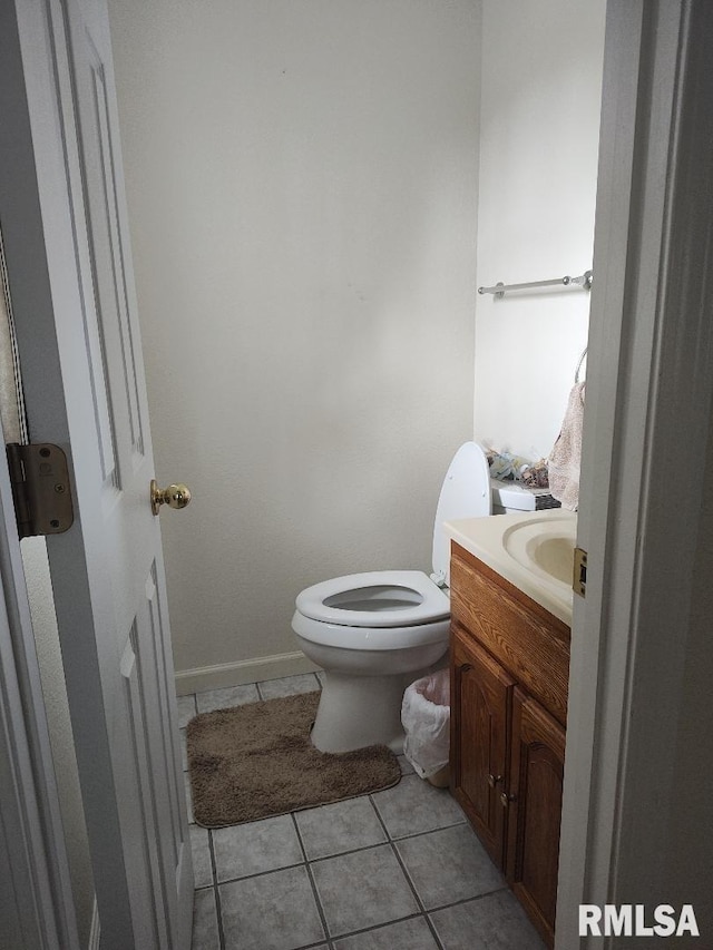bathroom with tile patterned flooring, toilet, and vanity