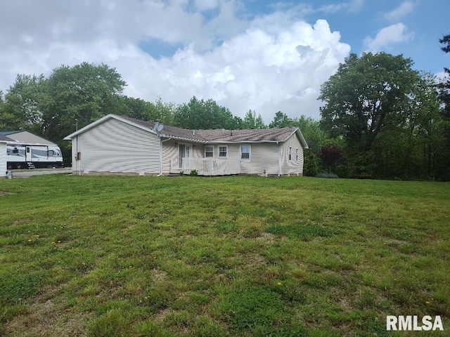 view of front of property featuring a front yard and a wooden deck
