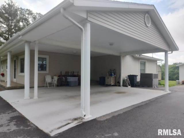 view of property exterior with an attached carport and central air condition unit