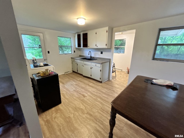 104 W Maple St, Cobden, IL 62920 - kitchen with a sink, white cabinetry, light countertops, and light flooring