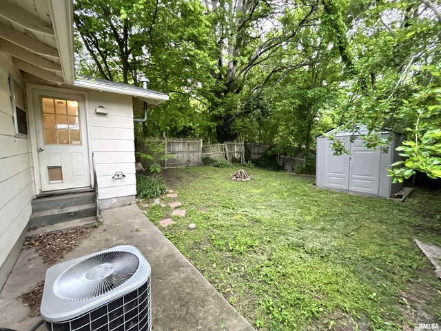 104 W Maple St, Cobden, IL 62920 - view of yard with entry steps, central AC unit, a storage shed, and an outdoor structure