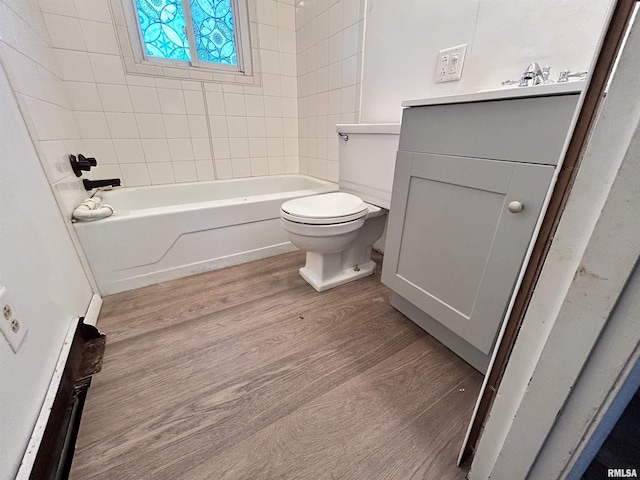 104 W Maple St, Cobden, IL 62920 - bathroom with wood finished floors, toilet, vanity, and tub / shower combination