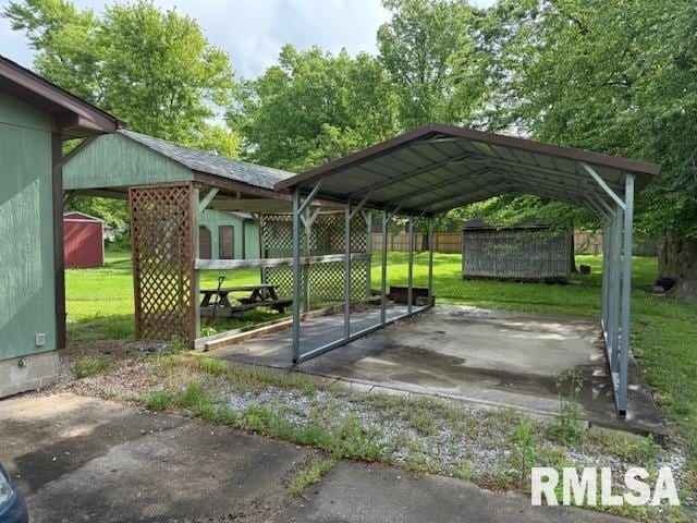 1308 Main St, Carterville, IL 62918 - view of parking with a detached carport and a storage unit