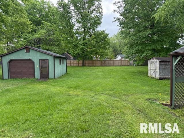 1308 Main St, Carterville, IL 62918 - view of yard with an outbuilding, a garage, and a storage unit