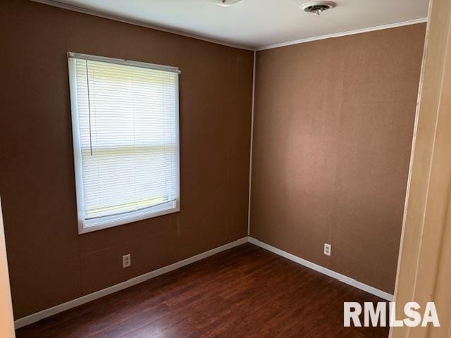 1308 Main St, Carterville, IL 62918 - spare room with dark wood-type flooring, baseboards, and ornamental molding