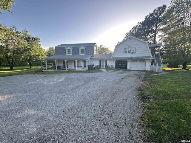 11729 Kevin Ln, Carterville, IL 62918 - view of front facade with a porch, a gambrel roof, gravel driveway, an attached garage, and a front lawn