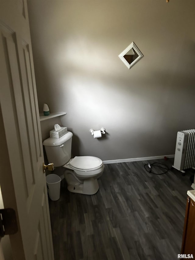 11729 Kevin Ln, Carterville, IL 62918 - bathroom featuring radiator heating unit, toilet, wood finished floors, and baseboards