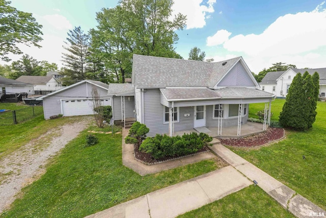 1104 Barham Ave, Johnston City, IL 62951 - view of front of property with roof with shingles, a detached garage, and a porch