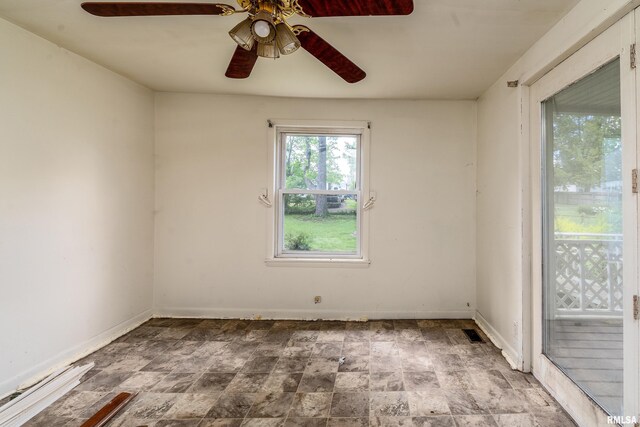 1104 Barham Ave, Johnston City, IL 62951 - unfurnished room featuring a ceiling fan, stone finish flooring, and baseboards