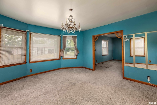 1104 Barham Ave, Johnston City, IL 62951 - carpeted spare room featuring a chandelier and baseboards