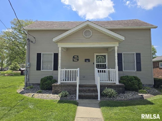 view of front of home with a front yard and covered porch