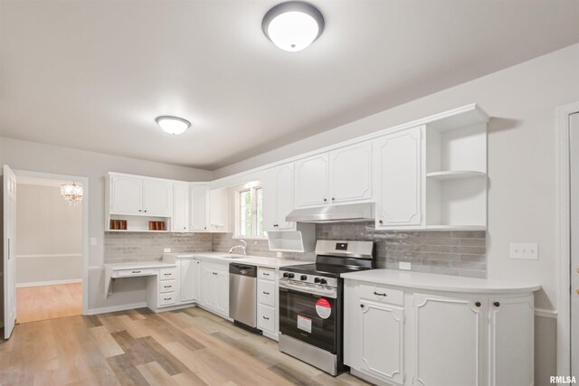 802 W Main St, Vienna, IL 62995 - kitchen with open shelves, stainless steel appliances, under cabinet range hood, a sink, and white cabinetry